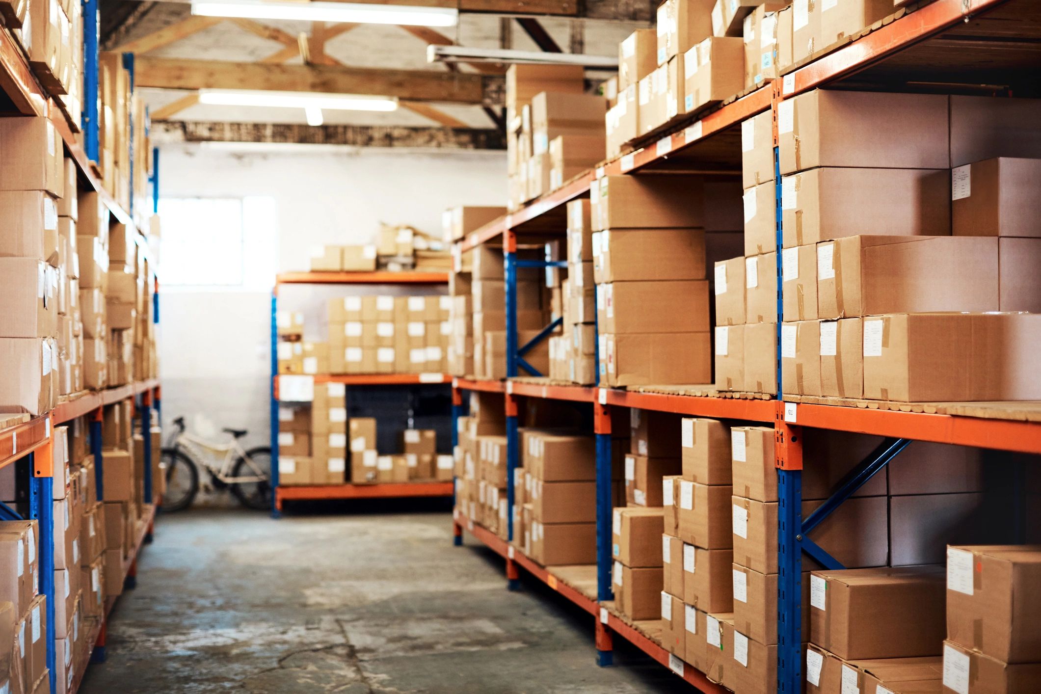 Shelving with labeled parts boxes in an organized auto parts inventory area