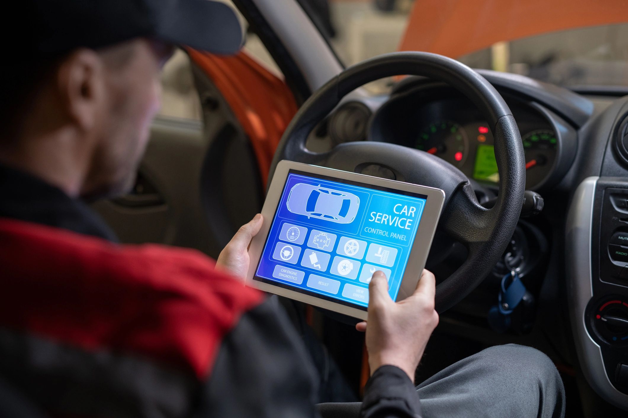 Mechanic using a tablet during a vehicle inspection