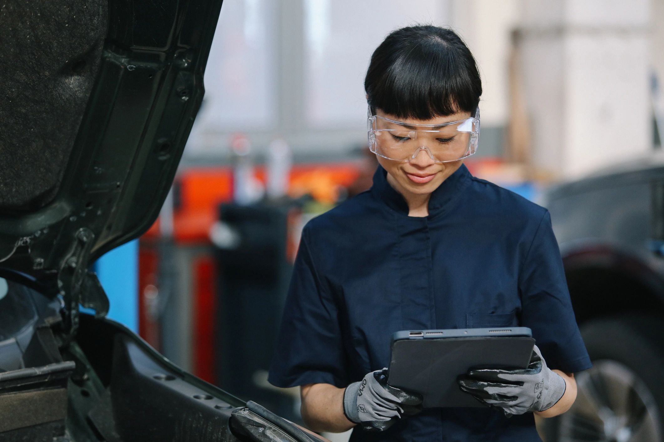 Technician performing a detailed vehicle inspection
