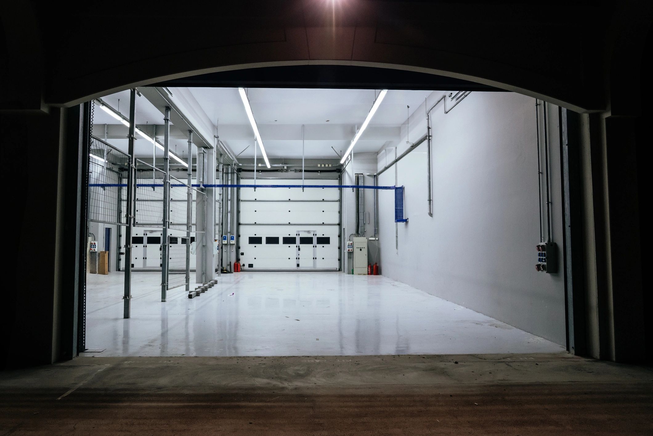 Modern auto repair service bay with open doors and clean workspace