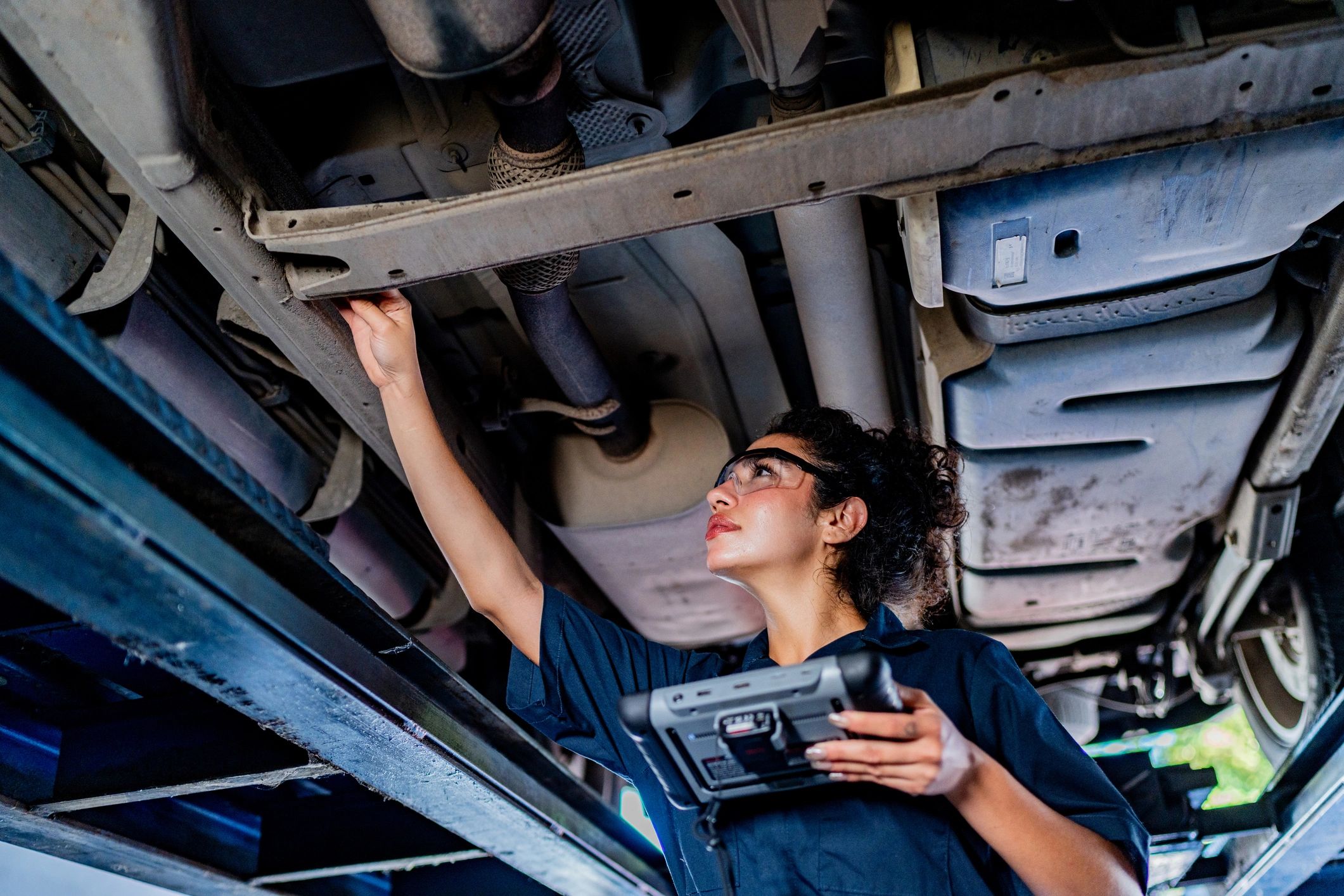 ASE-certified mechanic inspecting a vehicle at an auto repair shop