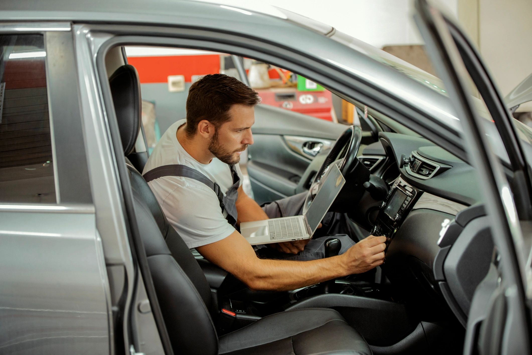 Technician using a laptop for vehicle diagnostics